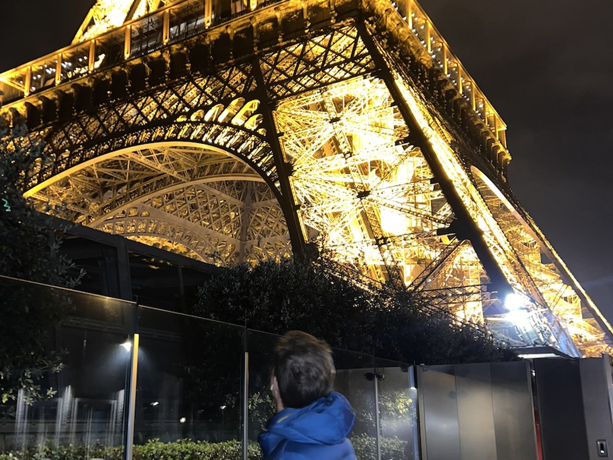 Nicolas beneath the Eiffel Tower at night